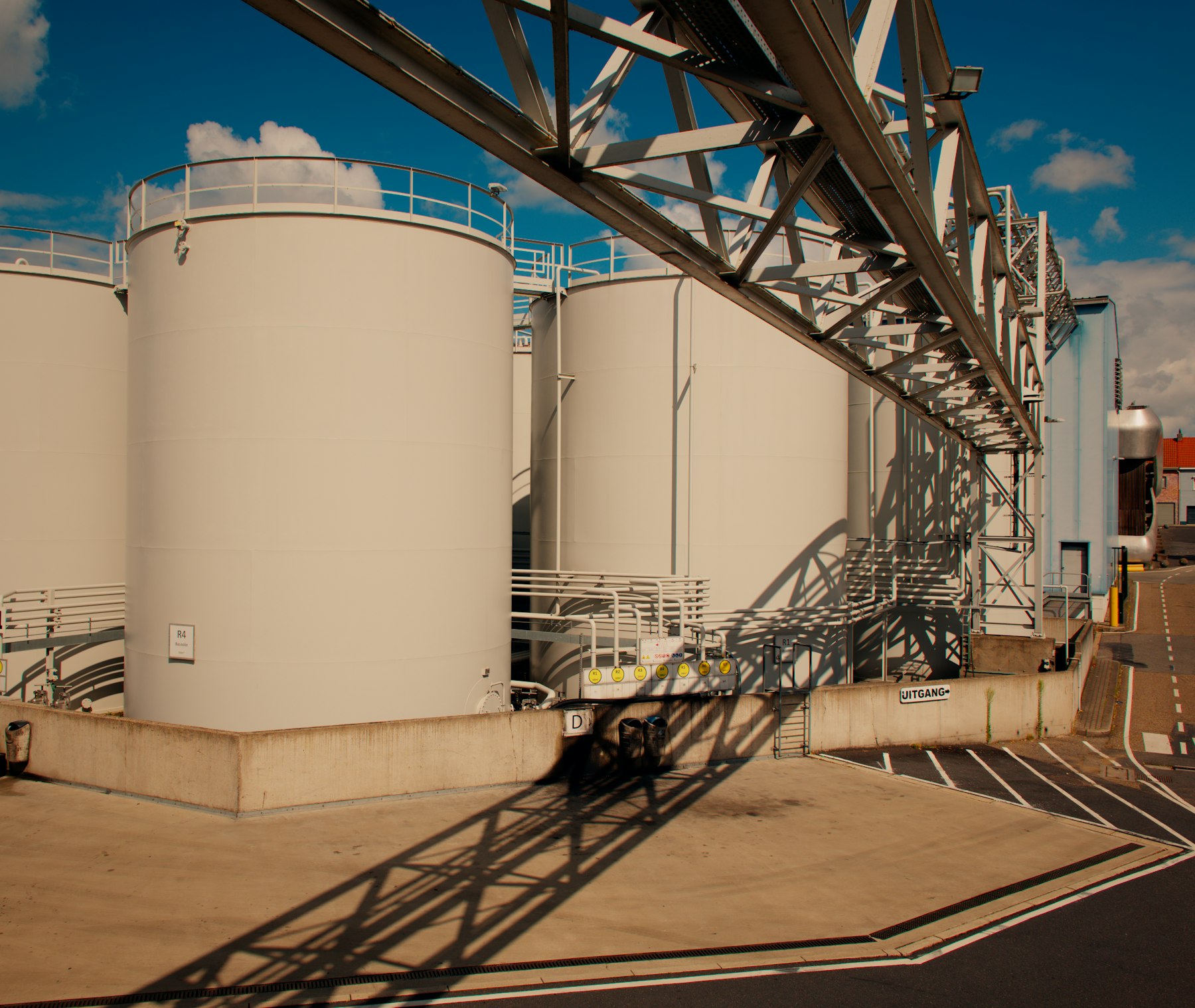Fuel storage tanks and overhead pipework at an industrial terminal