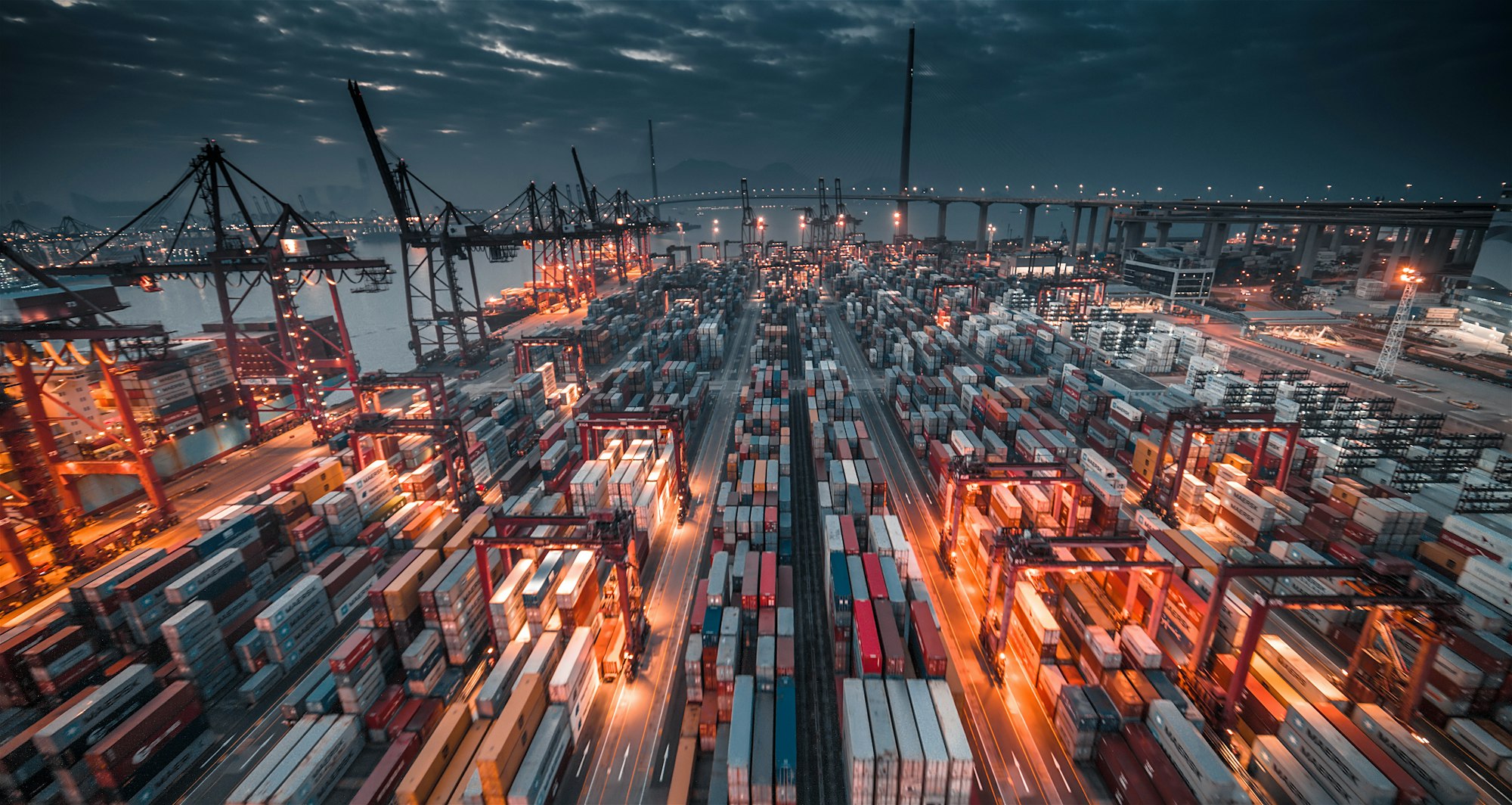Panoramic view of a container terminal illuminated at dusk
