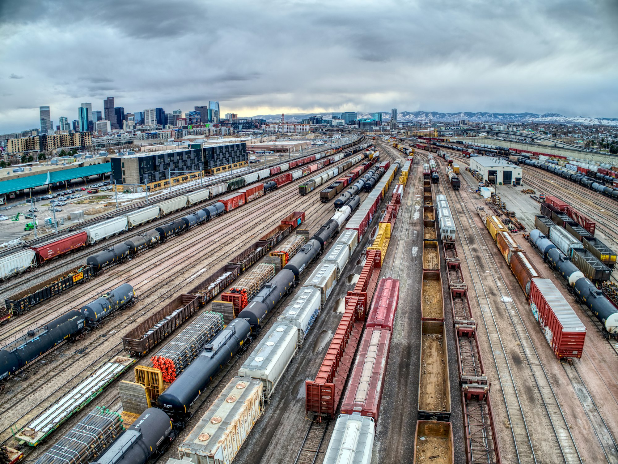 Wide view of a freight rail yard with multiple cargo tracks